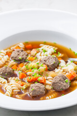 broth with liver dumplings, carrot and pasta