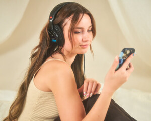 Woman listening to podcast at home