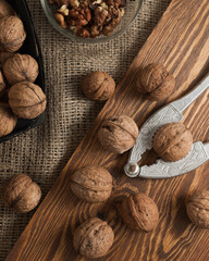 Walnuts on a wooden board. Nut peel them from shells. Von meshkovina. Rustic style. Vertical frame.   Close-up. 