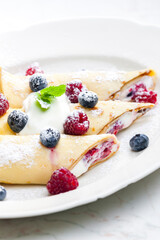 pankaces filled with blueberries, raspberries and cream