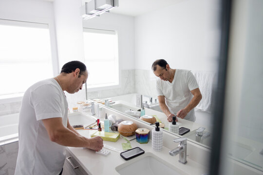 Man Taking Covid Rapid Antigen Test In Bathroom