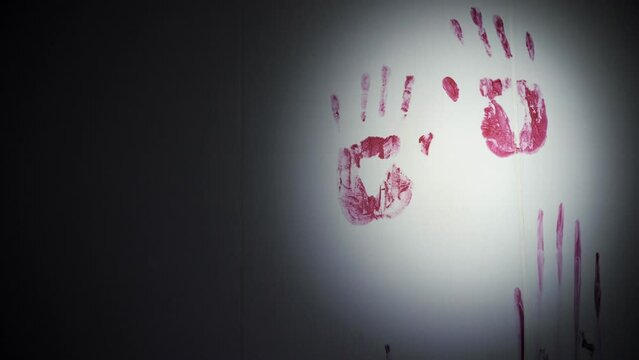 bloody handprints on the wall in the dark