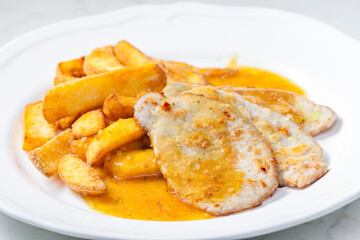 poultry meat on garlic with American potatoes and sauce