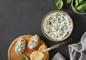 Spinach appetizer or dip with bread, top view, dark background, copy space - obrazy, fototapety, plakaty