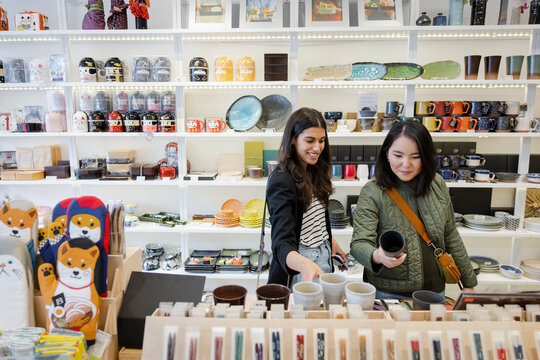 Happy Omen Friends Shopping For Mugs In Home Goods Store