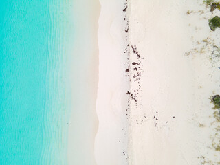 Aerial drone photograph of a white sandy beach in the Bahamas