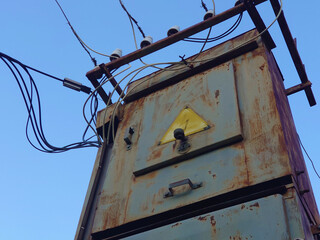Old electric power pole. Electrical transformer. Electricity city communications, power supply.