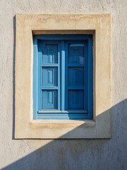 Old light blue wooden window closed with shutters
