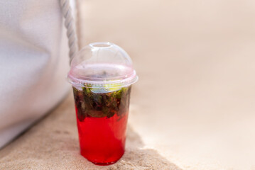 Summer cold beverage with strawberry on the beach