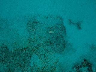 Aerial view of kayakers over reef in the bahamas