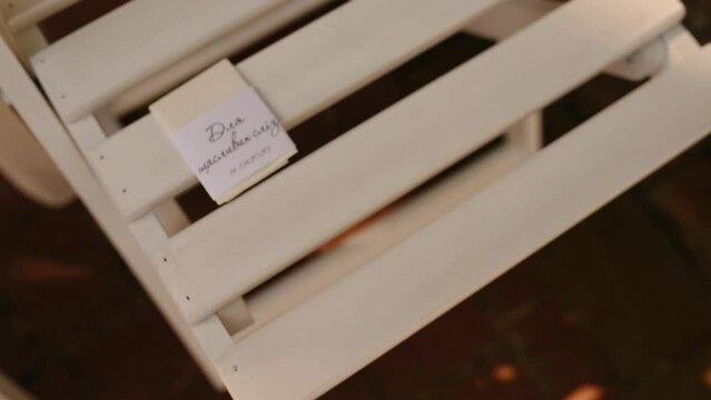 inscription: for happy tears top view highchair garden white wooden furniture napkin. off-site ceremony wedding seating of guests. decoration outdoor party nature. summer sun day