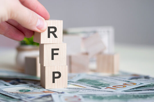 hand holding wood cube block with RFP text. Request For Proposal, business concept