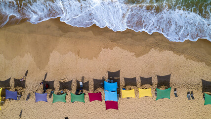 Aerial view of Caraiva beach, Porto Seguro, Bahia, Brazil. Colorful beach tents, sea and river