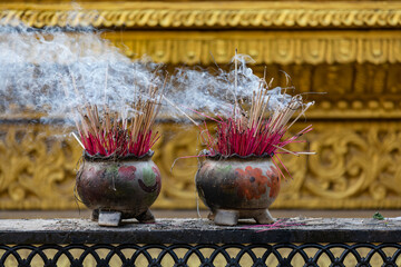 Decorated pots of incense sticks in a Buddhist temple in Bago, Myanmar