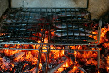 Delicious grilling sardines over the barbecue fire