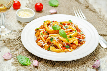 Eggplant tomato basil pasta in a plate on a wood backround