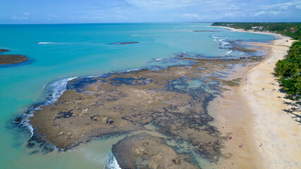 Aerial view of Praia do Espelho, Porto Seguro, Bahia, Brazil. Natural pools in the sea, cliffs and greenish water