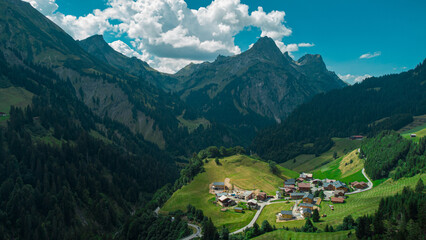 Beautiful austrian valley with village of Oberboden close to a nice road bridge with a hairpin turn on it with magnificent panorama of the mountains.