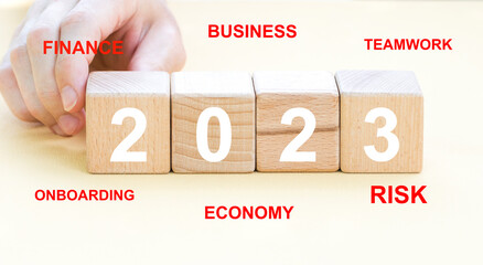 Wooden block from 2023 on a blurred background for preparation business concept in new year.
