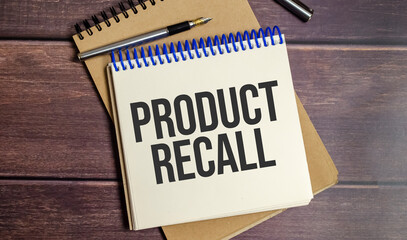 PRODUCT RECALL text on the wooden background