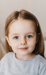Close-up portrait of 4 years old girl. Look in camera. Selective focus. Film grain