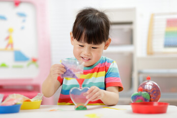 young girl making sand  crafts for homeschooling