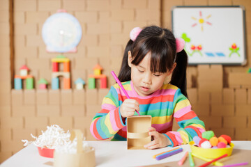 young girl hand make craft for home schooling