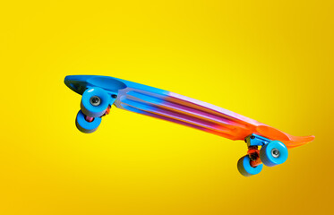 Side image of color skate board isolated over yellow