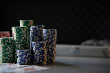 gambling, fortune, game and entertainment concept - a lot of casino chips on the surface of the poker table