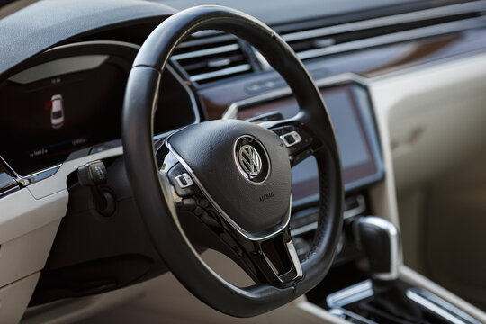 Close up of Volkswagen Passat B8 Logo on Car Steering Wheel.
