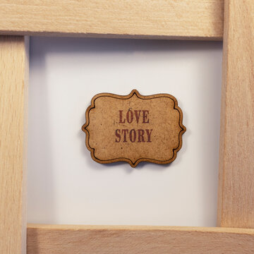 Love story was written on wooden surface. Wooden concept. Celebrations and special occasions.