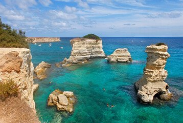 Salento, Apulia, astonishing view of stacks in the clean blue sea of Melendugno, Apuliia, Italy