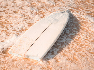 A broken surfboard at the beach