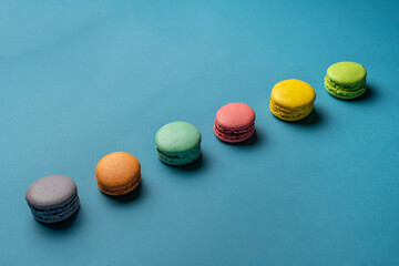 multi-colored set of french macaroons cookies on pastel background