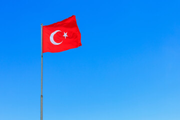 Turkish flag against the sky. The official name of the state is the Republic of Turkey, the capital is Ankara.