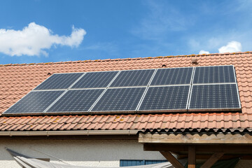 Photovoltaic panels installed on the roof of a house. Solar panels on a roof.