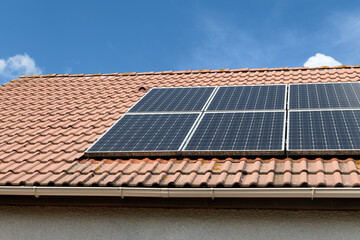 Photovoltaic panels installed on the roof of a house. Solar panels on a roof.