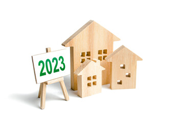 Houses and 2023 sign. Mortgage loan rates. Review real estate market in new year. Forecast new...