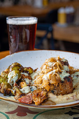 Smoked Meatloaf with Brussels Sprouts on a bed of Mashed Potato topped with Caramelized Onions and Country Gravy