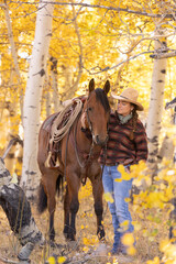 Wyoming Cowgirl in Autumn Aspen Trees