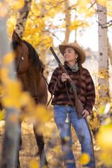 Wyoming Cowgirl in Autumn Aspen Trees