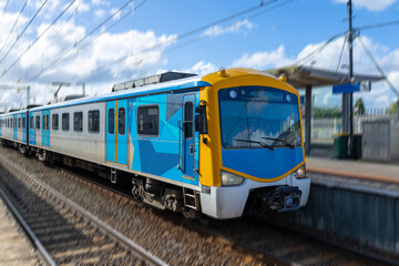 Commuter train approaching a train station in Melbourne Victoria Australia - obrazy, fototapety, plakaty
