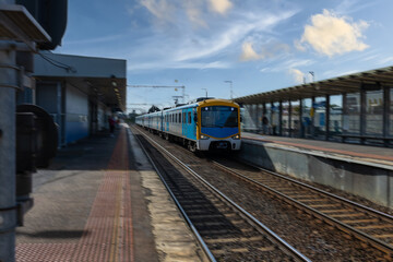 Commuter train approaching a train station in Melbourne Victoria Australia