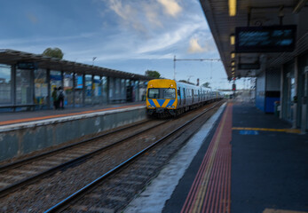 Obraz premium Commuter train approaching a train station in Melbourne Victoria Australia