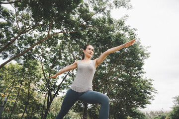 Asian woman make yoga posture in park. Concept for healthy lifestyle and oudoor life.