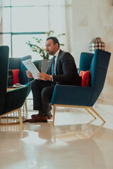 A modern businessman in a suit sits in a modern office and examines documents. Selective focus 