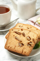 Slices of pear bread on white marble table, closeup. Homemade cake