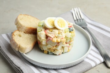 Delicious salad with crab sticks and eggs on grey table, closeup