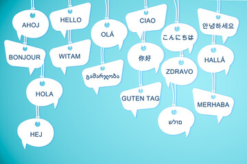 Speech bubbles with greeting words in different foreign languages on light blue background - obrazy, fototapety, plakaty