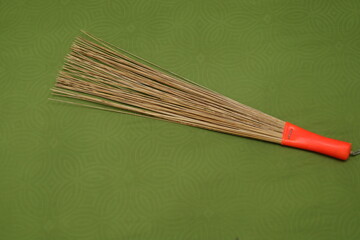 broom sticks on the mattress or bed. broom sticks from coconut leaf sticks are usually used to clean the bed from dust. natural cleaning tools from nature